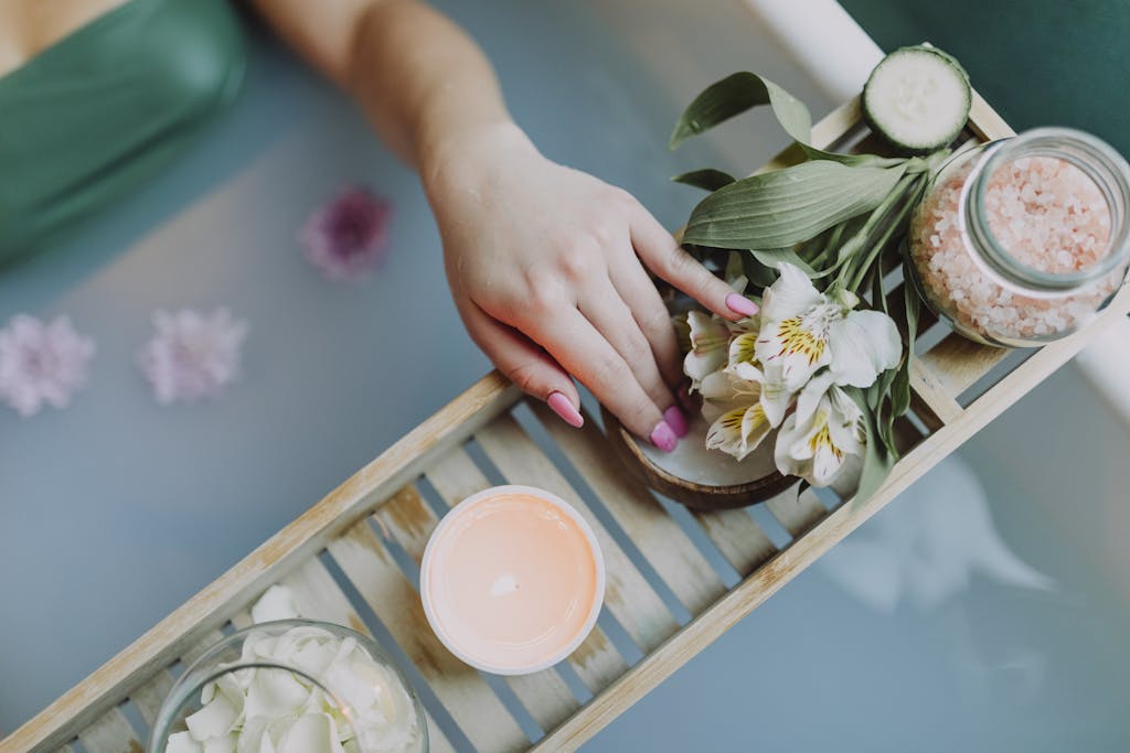 Elegant spa setting with flowers, bath salts, and calming ambiance for ultimate relaxation.